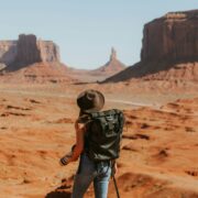 Woman with a backpack hiking in the desert
