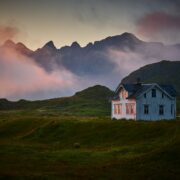Grey house on a green hill