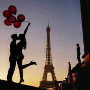 Silhouette of a couple in Paris with red balloons
