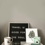 Sign saying "travel is good for the soul"