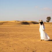 Woman wearing a white dress in the desert