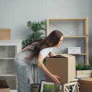 Woman moving boxes around the house