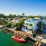 White villas on the water with a red boat in Miami